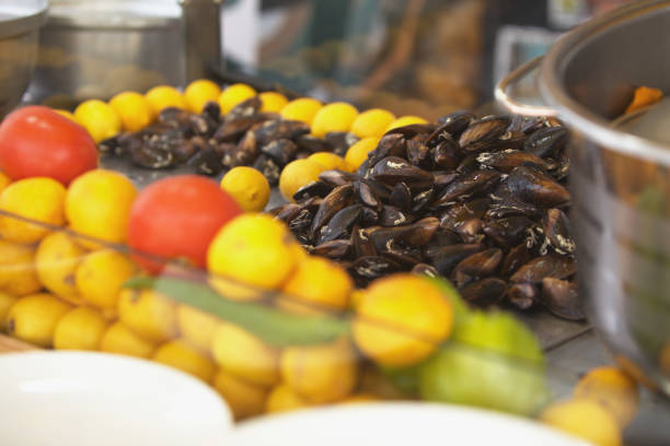 Delicious mussels with lemons on the counter.