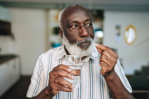 istock Senior man medicating at home 2156375135