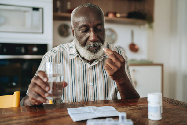 Senior man medicating at home