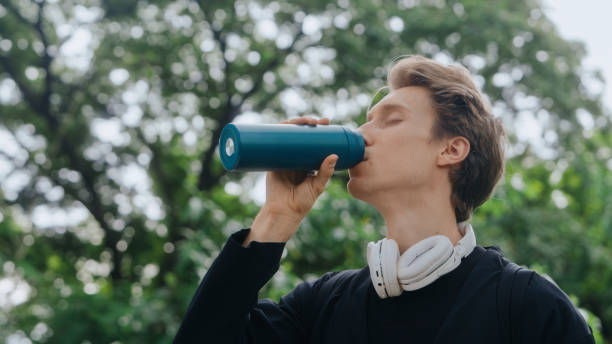 istock Hydration Break at park A man in serene surroundings takes a moment for a refreshing water break 2156377400
