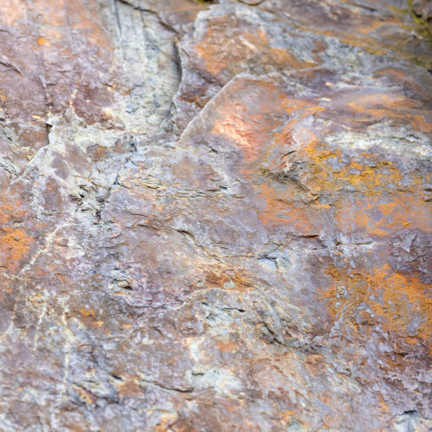Stone slab with a rough texture with color variations.
