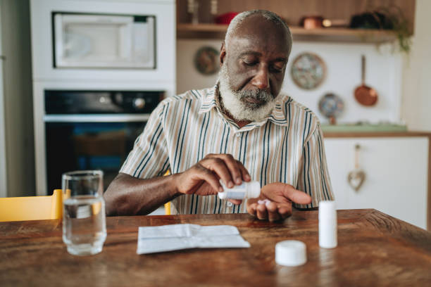 istock Senior man medicating at home 2156379561