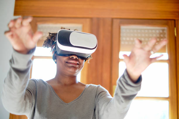 istock Young black woman testing a virual reality device. 2156380626