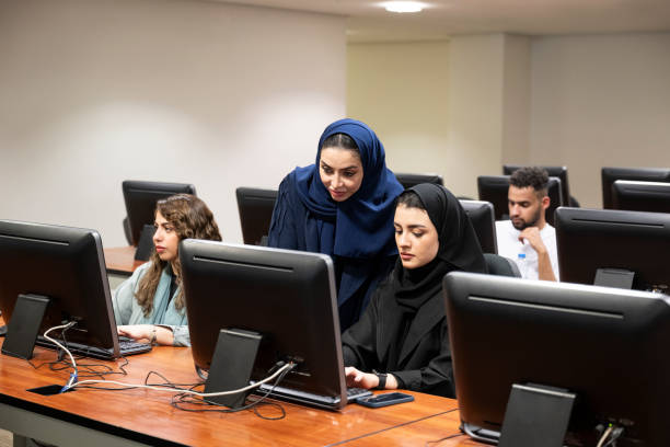 istock Students and teachers at desktop computer facility in modern Saudi university 2156381781