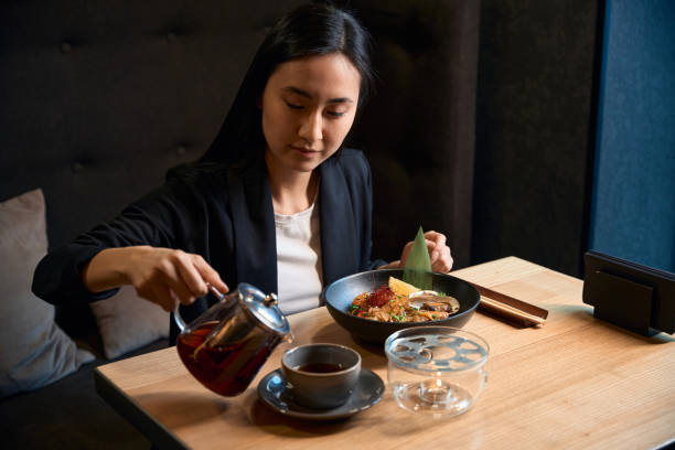 istock Young Asian woman spending lunch break in modern cuisine restaurant 2156382301