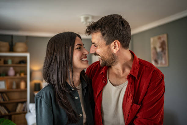istock Beautiful happy couple hugging while spending free time together at home 2156382577