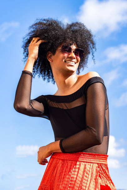 istock Genuine Joy: Non-Binary Person Illuminates with Smile and Sunglasses 2156385220
