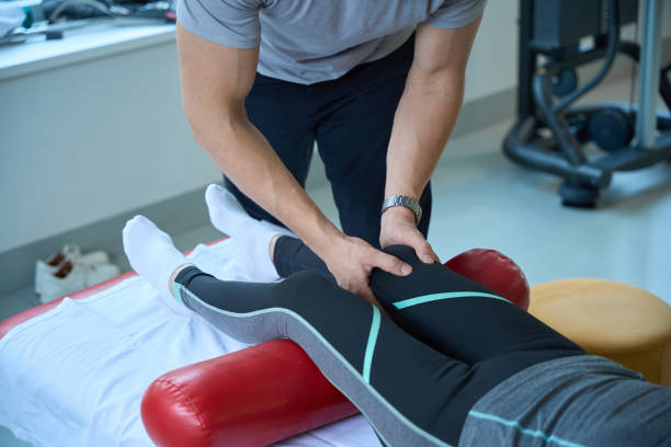 istock Specialist works with a patients knee joint 2156385887