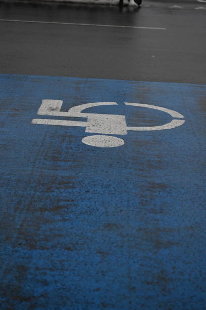 istock blue disabled parking sign as background, disabled parking sign on asphalt 2156386201