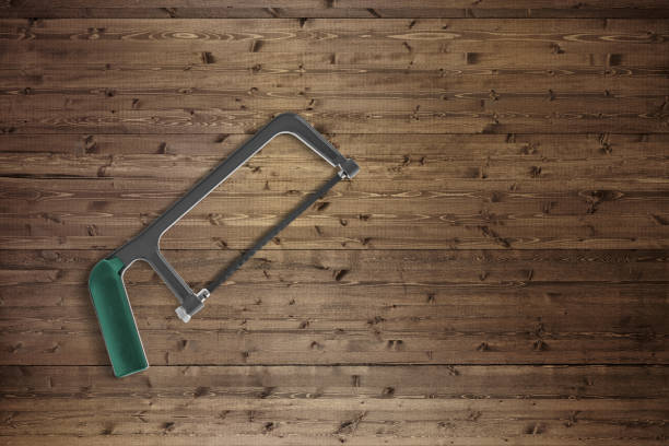 Metal arch hand saw on a wood background