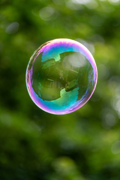 istock Large soap bubble is floating in the air with a green background 2156389029