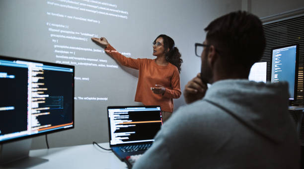 hispanic latin american software engineer developer use laptop computer program coding, projection screen presentation. programming language development, business technology, night work people concept - melhoria de competências imagens e fotografias de stock
