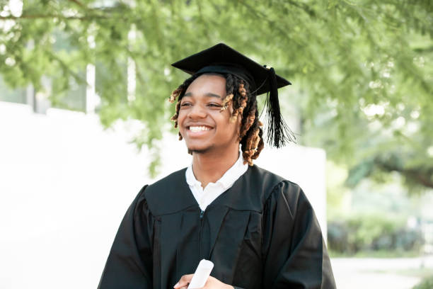 istock Smiling for the camera, a dashing young Black man celebrates his graduation. 2156394063