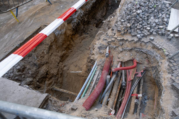 istock electric and high-speed Internet Network cables in red corrugated pipe are buried underground 2156396330