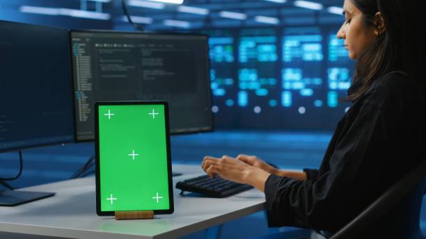 istock Chroma key device on desk used by worker supervising data center supercomputers 2156400712