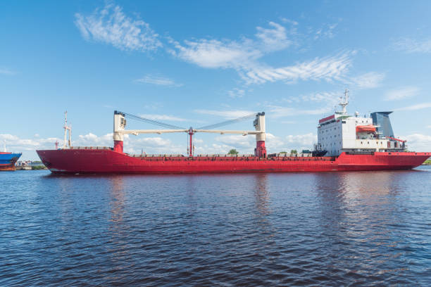 a large cargo ship on the roadstead on the river. background blue sky natural light. close-up.