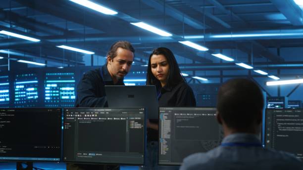 istock System administrators in server hub monitoring data center 2156401677