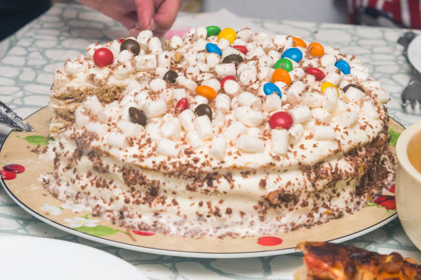 festive children's birthday cake is being cut. close-up.