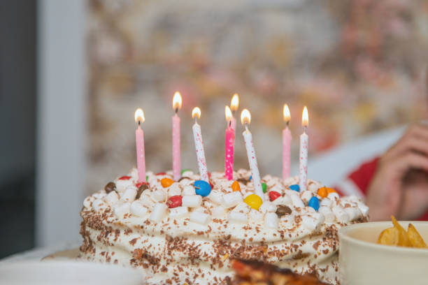 istock festive children's birthday cake with lighted candles 2156401714