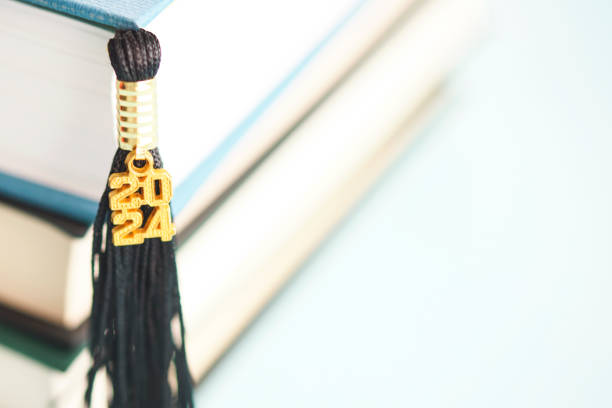 Graduation tassel for 2024 with a stack of books