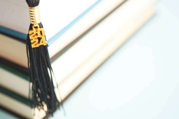 Graduation tassel for 2024 with a stack of books