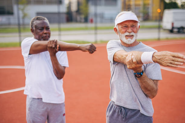 istock Two senior friends warming up before  playing basketball game. 2156401966