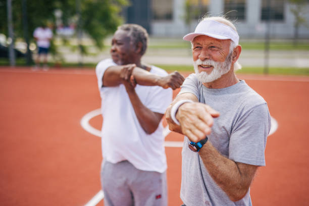 istock Two senior friends warming up before  playing basketball game. 2156402540