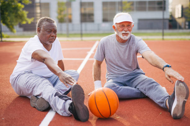istock Two senior friends warming up before  playing basketball game. 2156402689