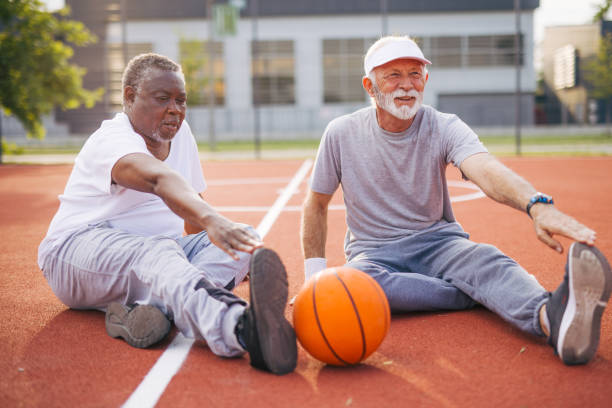 istock Two senior friends warming up before  playing basketball game. 2156402725