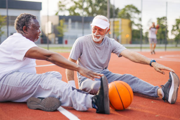 istock Two senior friends warming up before  playing basketball game. 2156402736