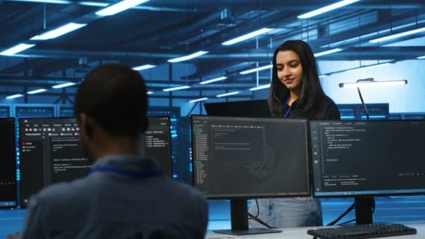 istock Cheerful supervisor in server room managing multiethnic team of technicians 2156403003
