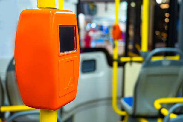 istock Contactless payment system. Orange validator. Bank transfer in public transport. Writing off money from the travel card. Collection of tolls. Payment by travel card. Public Electric Transport. 2156403577