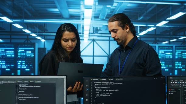 istock Coworkers examining equipment in data center, ensuring system security 2156403723