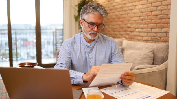 istock Mature man counting his costs 2156404092