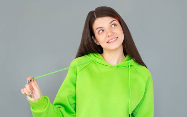 istock Young thoughtful secretary dreaming on gray background 2156406749
