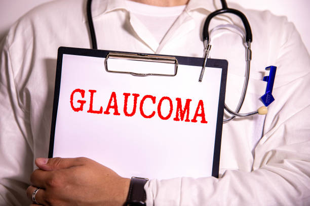 istock White sticker with text Glaucoma lying on medical robe with a stethoscope. 2156407255