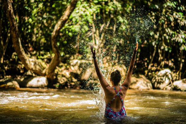 istock young woman outdoors at the river with her back to the river 2156412920