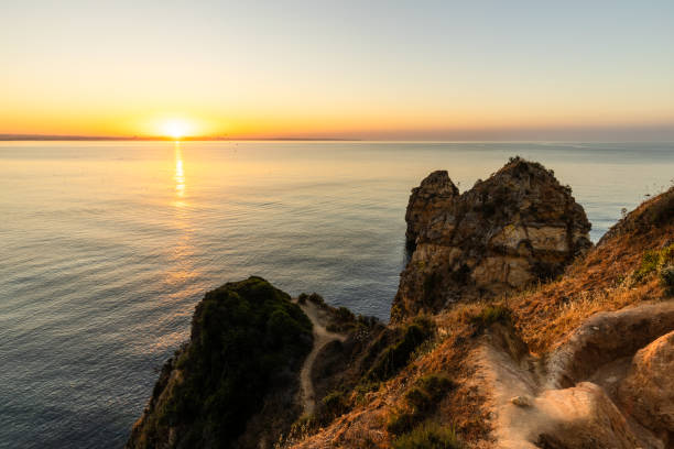 istock Peaceful sunrise illuminating cliffs of Ponta da Piedade 2156417955