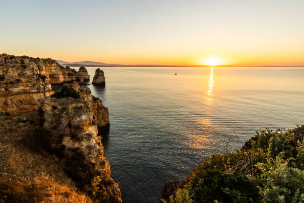 istock Peaceful sunrise illuminating cliffs of Ponta da Piedade 2156418039