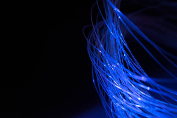 istock abstract background with lights in optical fibers on a black background 2156418173