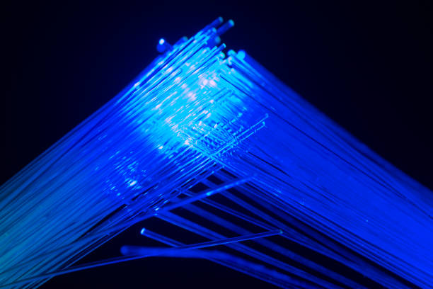 istock abstract background with lights in optical fibers on a black background 2156418199