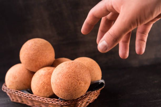 Hand taking some round colombian traditional food