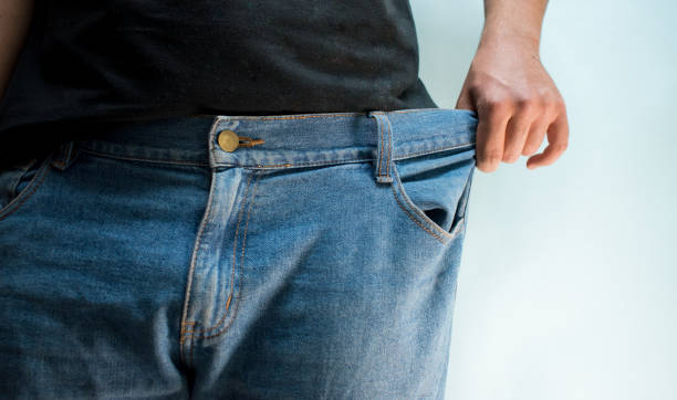 istock Man wearing and stretching his blue jeans 2156419854