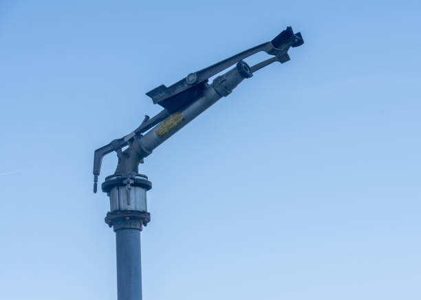 A metal water cannon against the blue sky