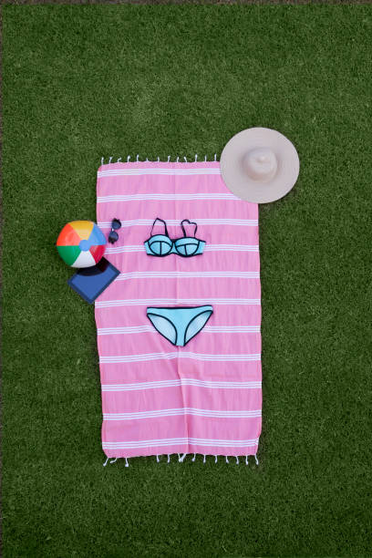 Folded towel in an animal shape left on bed holding a \