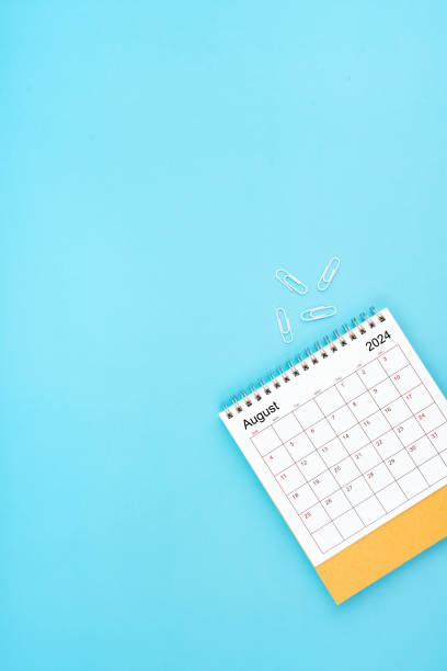 istock Desk calendar for August 2024 and white paper clip on a light blue. 2156424579