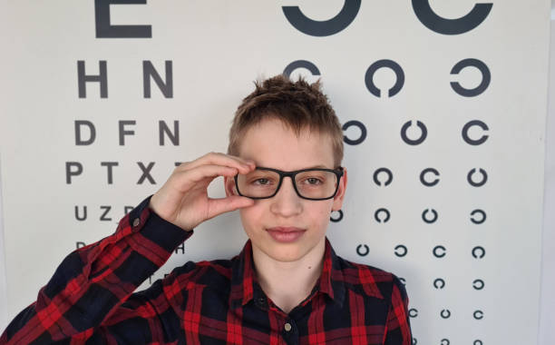 istock Young Boy Wearing Glasses During Eye Exam 2156426868