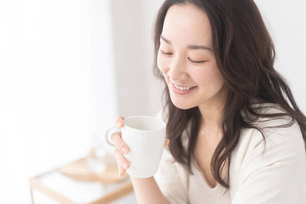 istock A woman is drinking a drink. 2156428786