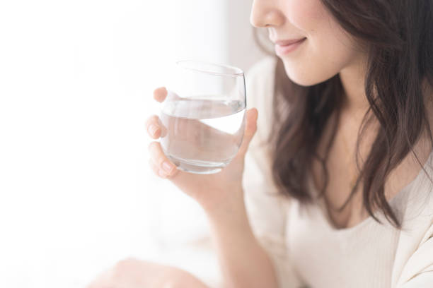 A woman is drinking water.
