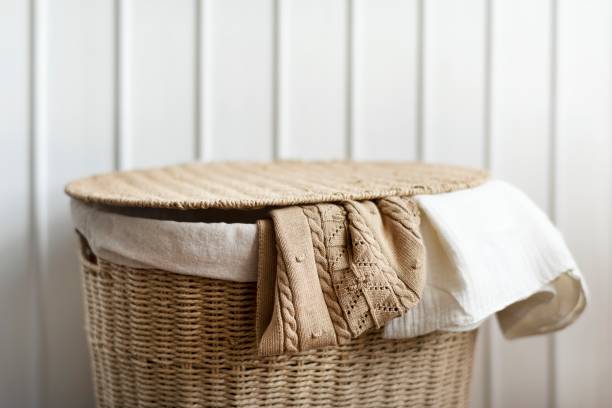 istock Knitted clothes in a rattan basket 2156433737